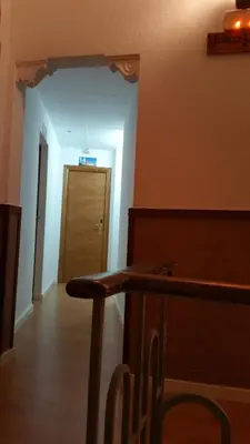 a room with a hallway with a door in the background at Hostal Restaurante Cornella in Cornellà de Llobregat