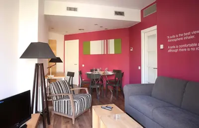 a living room with a couch and a table at MH Apartments Suites in Barcelona