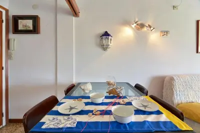 a dining room table with a blue and white table cloth at Oasis Near Barcelona Pool Tennis Beach in Sant Andreu de Llavaneres