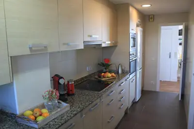 a kitchen with a counter with fruit on it at GAVA 2 BEACHFRONT PENTHOUSE in Gavà