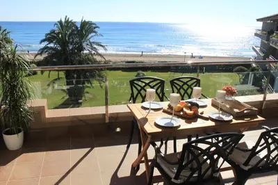 a table on a balcony with a view of the beach at GAVA 2 BEACHFRONT PENTHOUSE in Gavà