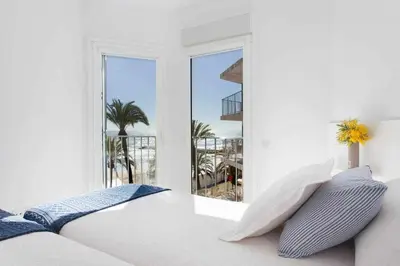 a bedroom with a bed and a view of the ocean at Sitges Bellavista · Vistas Espectaculares del Mar in Sitges
