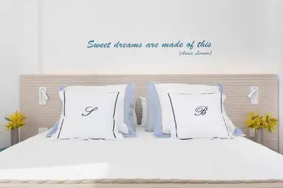 a bed with white sheets and pillows with the wordssweet dreams are made up at Sitges Bellavista · Vistas Espectaculares del Mar in Sitges