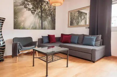 a living room with a couch and a table at Mar Bella Beach Apartments in Barcelona