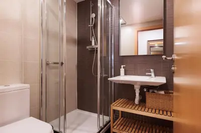 a bathroom with a shower and a sink and a toilet at Mar Bella Beach Apartments in Barcelona