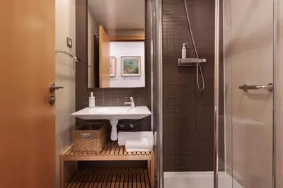a bathroom with a sink and a shower at Mar Bella Beach Apartments in Barcelona