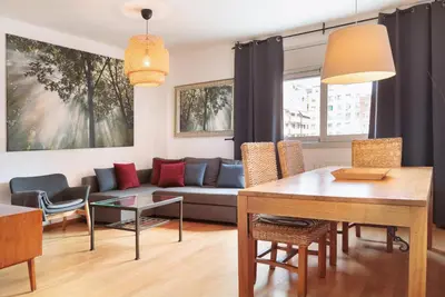 a living room with a couch and a table at Mar Bella Beach Apartments in Barcelona