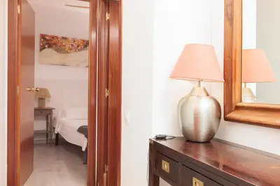 a lamp sitting on a dresser next to a mirror at Portal Del Angel Barcelona Apartment in Barcelona