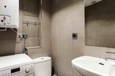a small bathroom with a toilet and a sink at Elegant Eixample Apartment nicely decorated in Barcelona