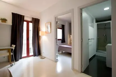 a bathroom with a walk in shower and a glass door at Old City Beach House in Barcelona