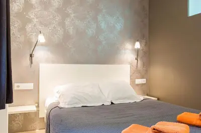 a bedroom with a bed with two towels on it at Old City Beach House in Barcelona