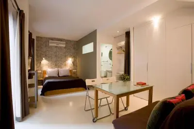 a bedroom with a bed and a desk in a room at Old City Beach House in Barcelona