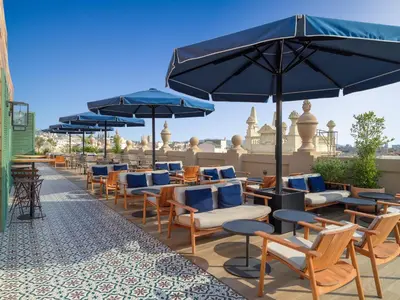 a row of chairs and umbrellas on a patio at H10 Madison 4* Sup in Barcelona