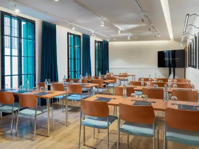 a conference room with tables and chairs and windows at H10 Madison 4* Sup in Barcelona