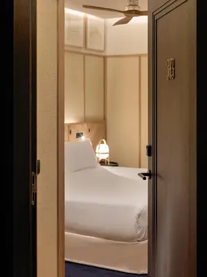 a bedroom with a white bed and a room with a ceiling at H10 Madison 4* Sup in Barcelona