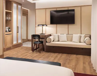 a hotel room with a couch and a desk at H10 Madison 4* Sup in Barcelona