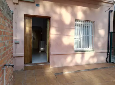 an open door to a bathroom in a pink building at Casa Carmen Barcelona in El Prat de Llobregat