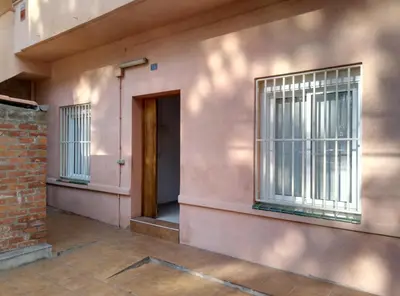 a pink building with windows and a door at Casa Carmen Barcelona in El Prat de Llobregat