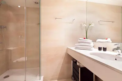 a bathroom with a sink and a shower at Inside Barcelona Apartments Mercat in Barcelona
