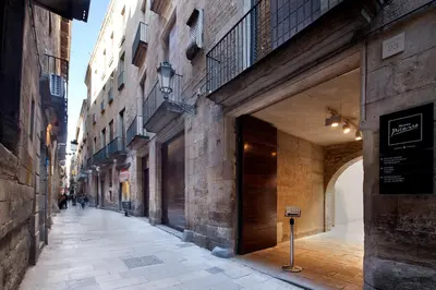 an empty street with an alley between two buildings at Inside Barcelona Apartments Mercat in Barcelona