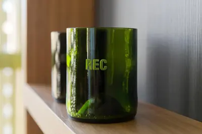 a green coffee cup sitting on a shelf at Hotel Rec Barcelona - Adults Only in Barcelona