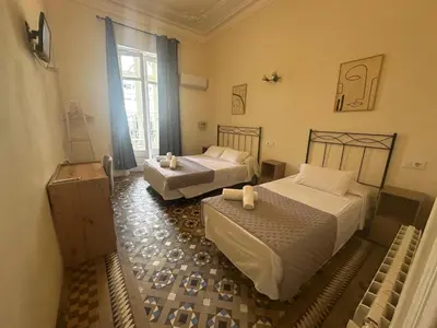 a hotel room with two beds and a window at Hostal Balmes Centro in Barcelona
