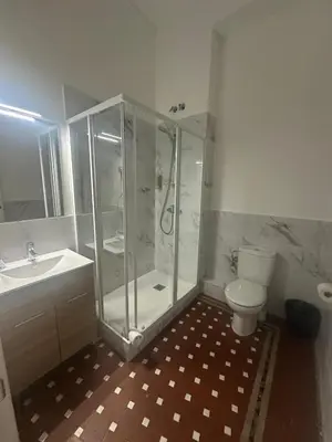 a bathroom with a shower and a toilet and a sink at Hostal Balmes Centro in Barcelona