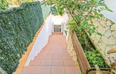 a stairway in a garden with a stone wall at Nice Home In St Cebrià De Vallalta in Sant Cebrià de Vallalta
