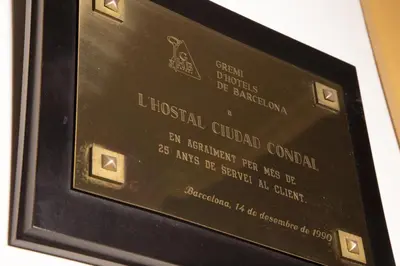 a plaque for a hospital cultural center on a wall at Ciudad Condal Hostal - Paseo de Gracia in Barcelona