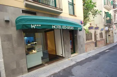 a store front with a green awning on a building at Sitges Apartment in Sitges