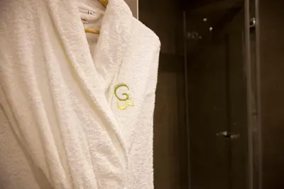 a white towel with a gold emblem on it at Hostal Goya in Barcelona