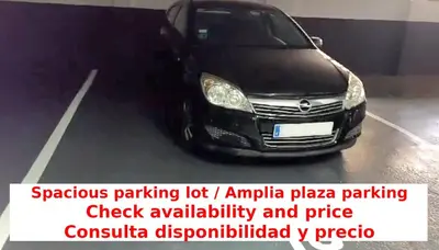 a black car parked in a parking lot at Luxury Beach Apartment, next to the sea in Premiá de Mar