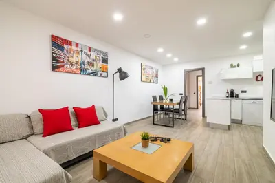 a living room with a couch and a table at Luxury Beach Apartment, next to the sea in Premiá de Mar