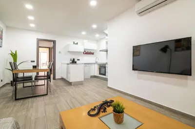 a living room with a large flat screen tv on a wall at Luxury Beach Apartment, next to the sea in Premiá de Mar