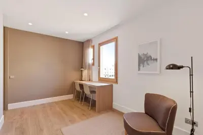 a living room with a desk and a chair at Fisa Rentals Gran Via Apartments in Barcelona