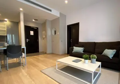a living room with a couch and a table at Fisa Rentals Gran Via Apartments in Barcelona