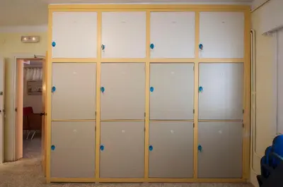 a locker room with white and blue doors at Studio Hostel in Barcelona