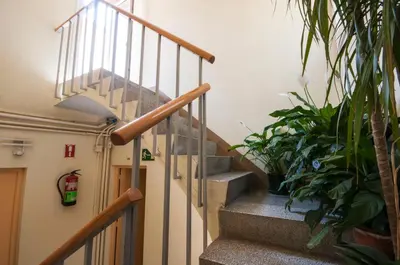 a staircase in a building with potted plants at Studio Hostel in Barcelona