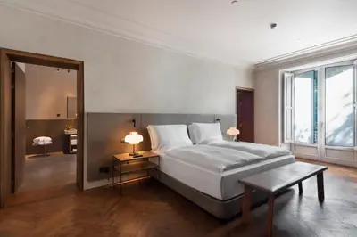 a bedroom with a large white bed and a mirror at Alma Barcelona GL in Barcelona