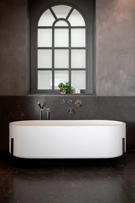 a white bath tub in a room with a window at Alma Barcelona GL in Barcelona