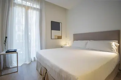 a bedroom with a large white bed and a window at Storni Barcelona by Forget me not in Barcelona