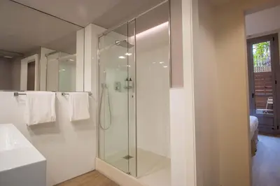 a bathroom with a glass shower and a sink at Storni Barcelona by Forget me not in Barcelona