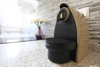a hair dryer sitting on a counter in a bathroom at Fira Barcelona Apartment in Hospitalet de Llobregat