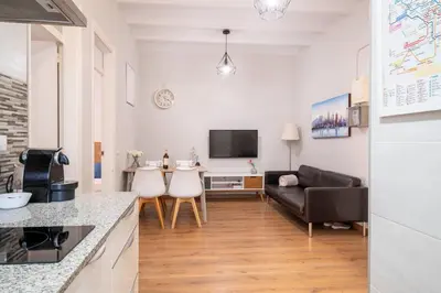 a living room with a couch and a table at Fira Barcelona Apartment in Hospitalet de Llobregat