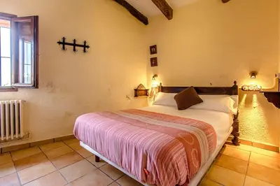 a bedroom with a large bed in a room at Catalunya Casas Country Chateau for 22 persons - close to Sitges! in Les Masuques