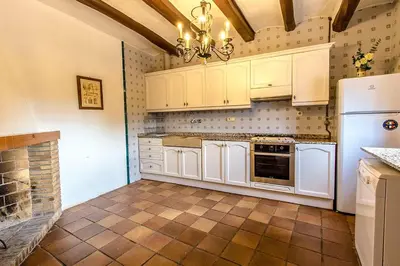 a kitchen with white cabinets and a refrigerator at Catalunya Casas Country Chateau for 22 persons - close to Sitges! in Les Masuques