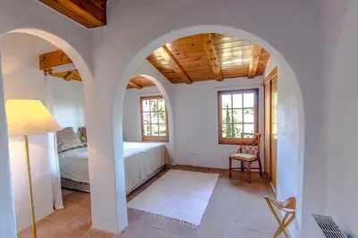 a bedroom with a bed and a table and a chair at Catalunya Casas Majestic Villa and Views , 30km to Barcelona in Corbera de Llobregat