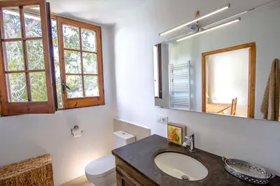 a bathroom with a sink and a toilet and a mirror at Catalunya Casas Majestic Villa and Views , 30km to Barcelona in Corbera de Llobregat