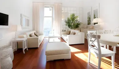 a living room with white furniture and a dining room at You Stylish City Center Apartments in Barcelona