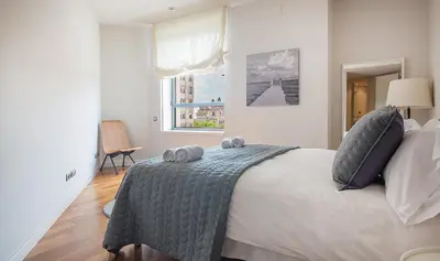 a bedroom with a bed with two towels on it at You Stylish City Center Apartments in Barcelona